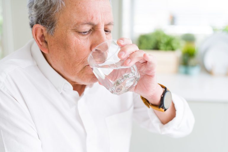 elderly man drinking water during covid19