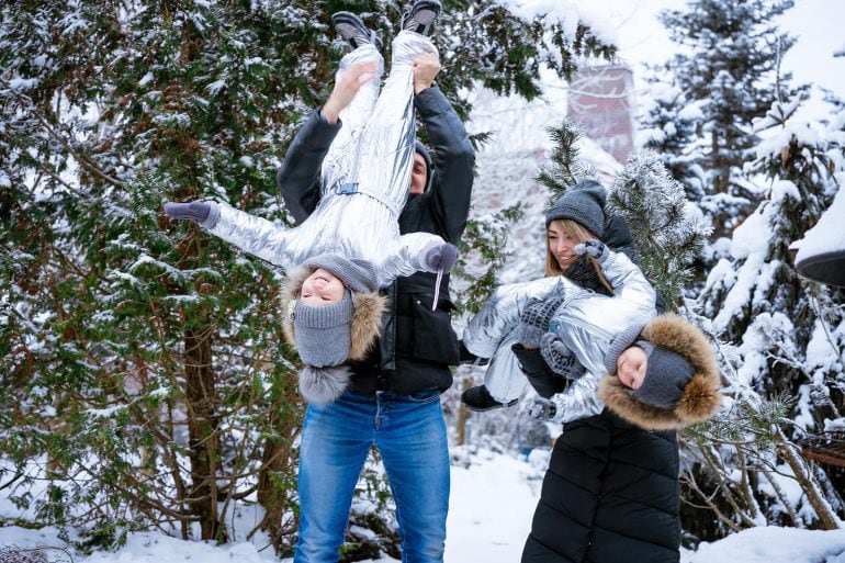 family playing in the snow