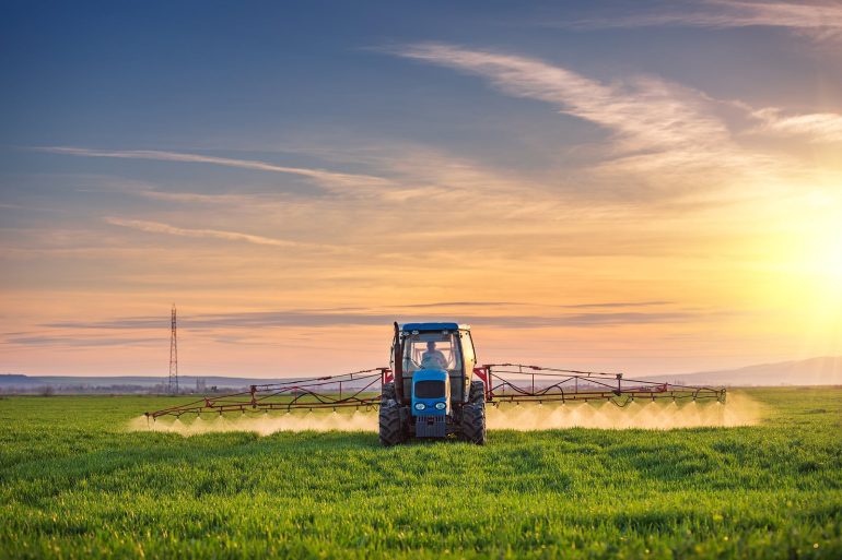 farmer spraying pesticides