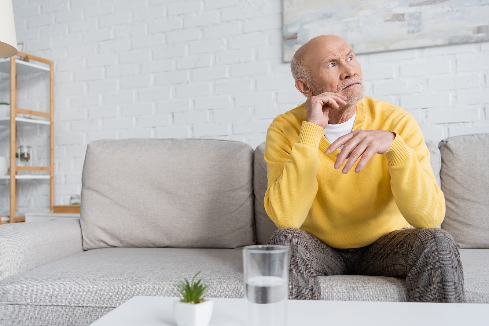 elderly man sitting next to water