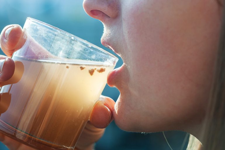 woman drinking dirty water