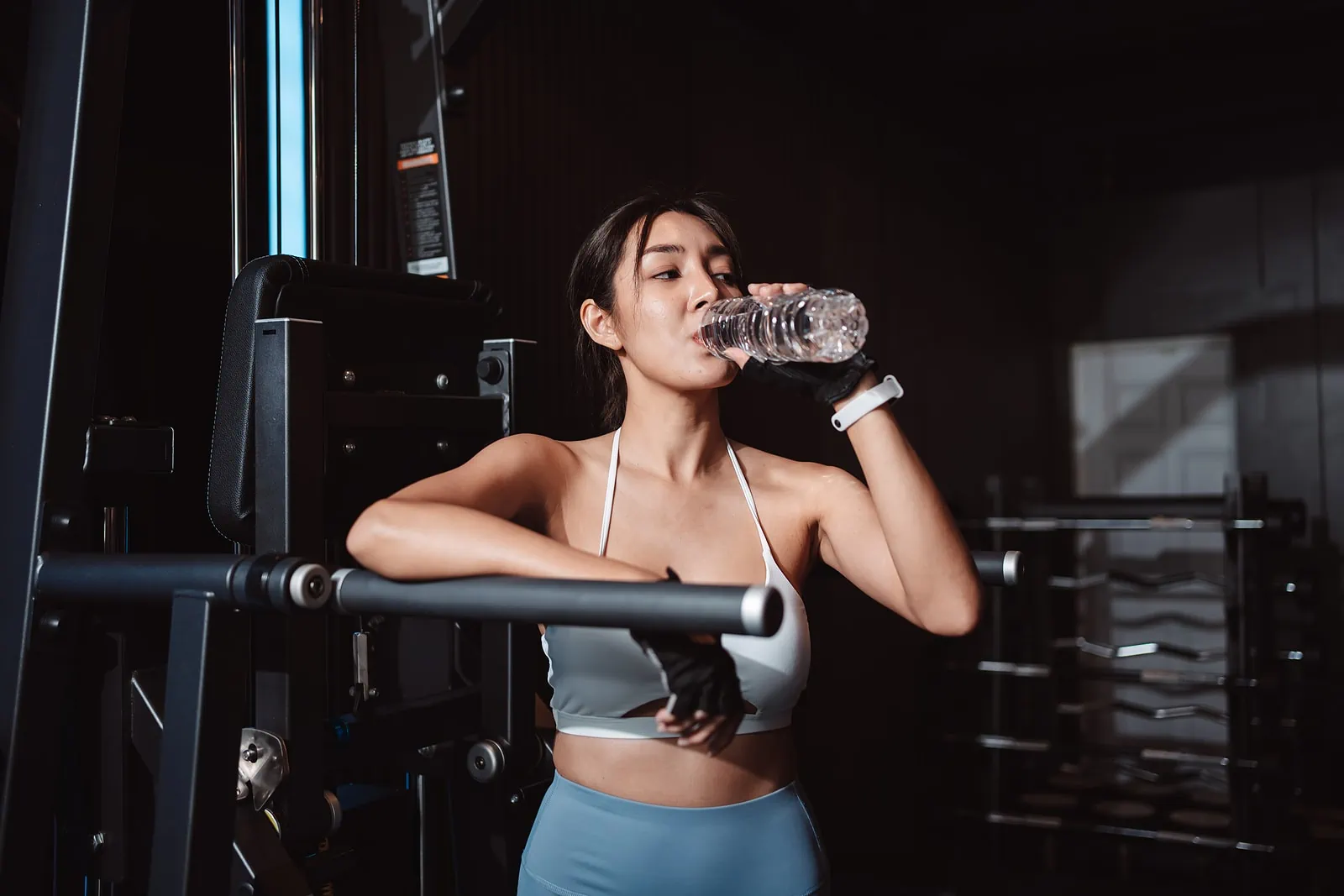 woman drinking water in a gym
