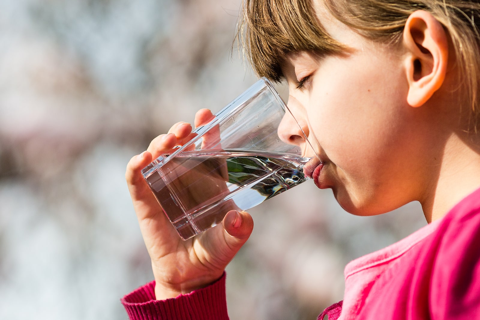 girl drinking a glass of water